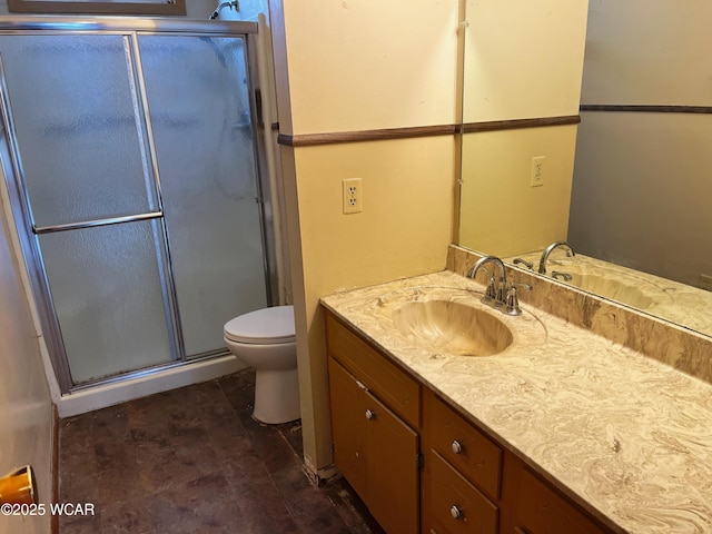 full bathroom with a stall shower, vanity, and toilet