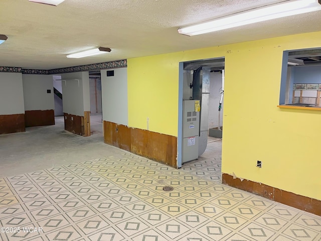 empty room with concrete flooring and a textured ceiling