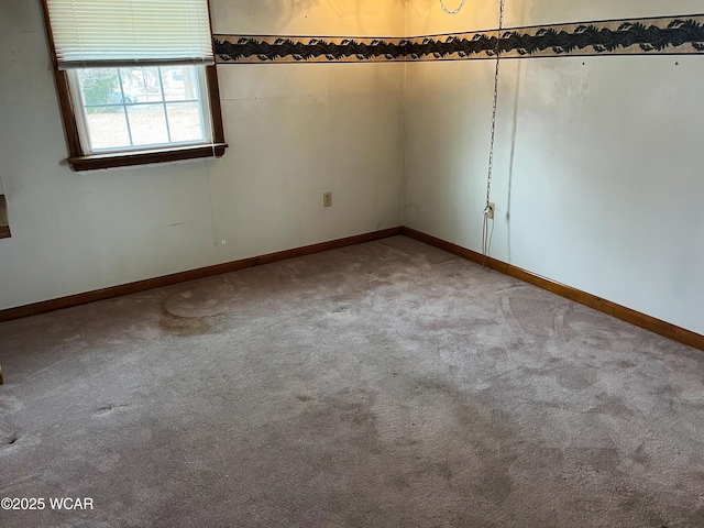 carpeted empty room with baseboards