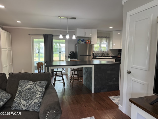 1821 Rice Ave, Lima, OH 45805 - living room with dark wood-style flooring, recessed lighting, and crown molding
