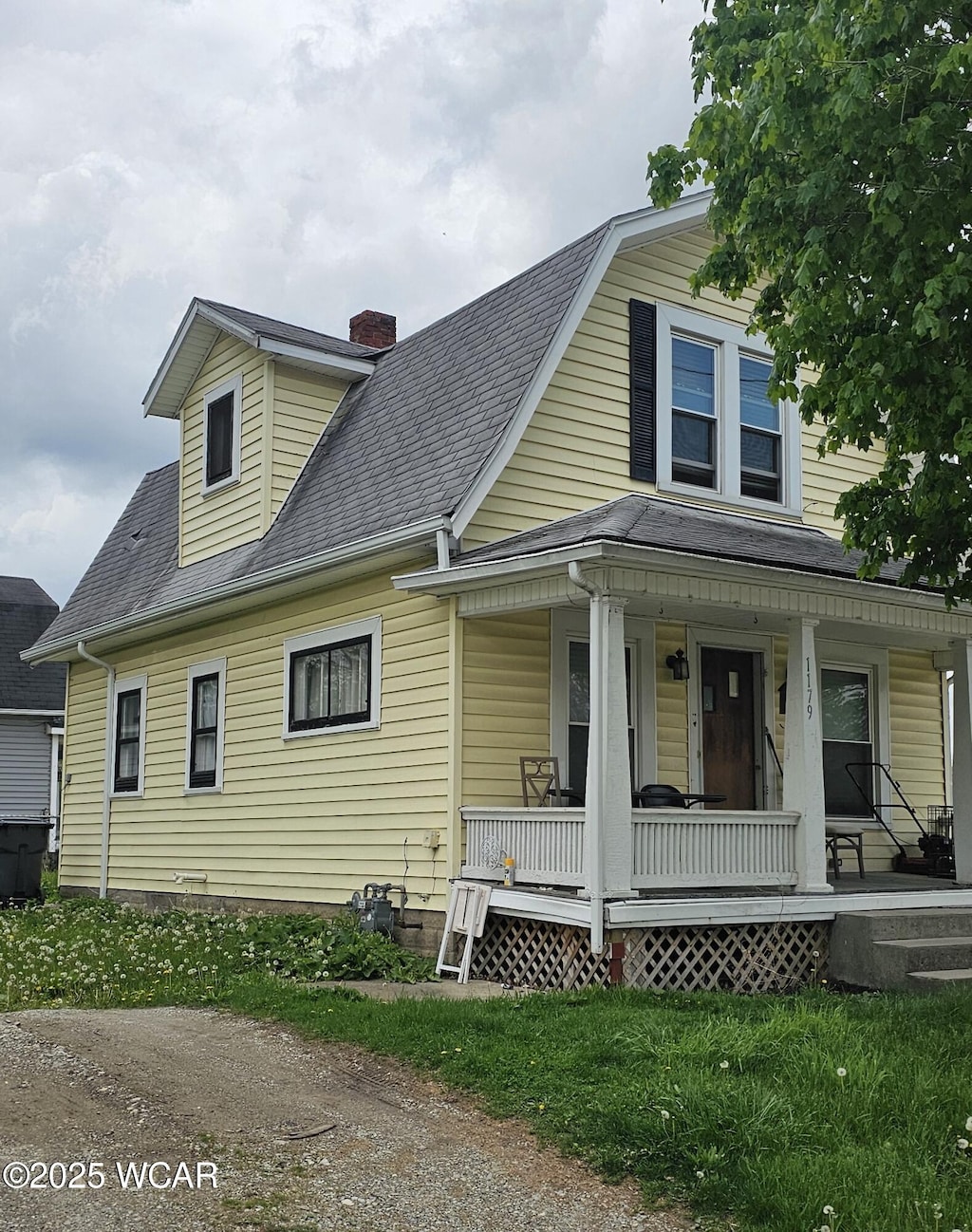 1179 W High St, Lima, OH 45805 - view of front facade with covered porch, a chimney, and roof with shingles