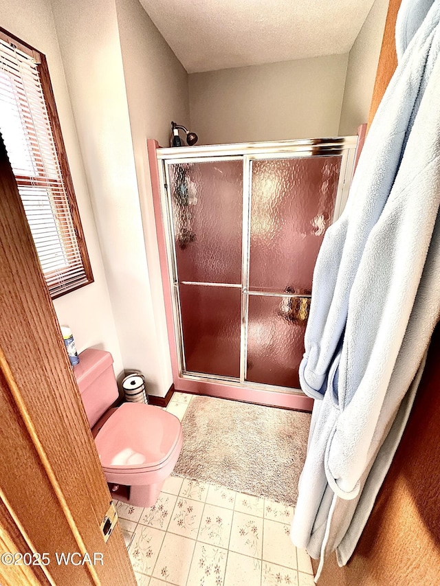 4095 N Cole St, Lima, OH 45807 - full bathroom featuring a shower stall, toilet, a textured ceiling, and tile patterned floors