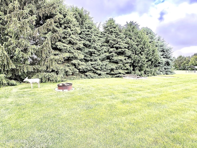 4095 N Cole St, Lima, OH 45807 - view of grassy yard with a fire pit