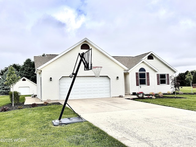 4095 N Cole St, Lima, OH 45807 - view of front of home featuring a garage, a front yard, a shingled roof, driveway, and an outbuilding