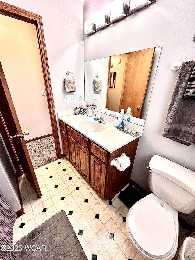 4095 N Cole St, Lima, OH 45807 - bathroom featuring vanity, toilet, and baseboards