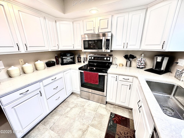 4095 N Cole St, Lima, OH 45807 - kitchen with stainless steel appliances, white cabinets, light countertops, and a sink