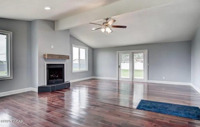 unfurnished living room with ceiling fan, a fireplace, dark hardwood / wood-style flooring, and lofted ceiling with beams