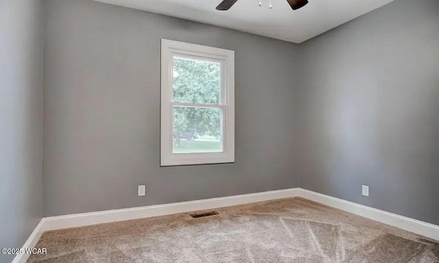 empty room featuring carpet floors and ceiling fan