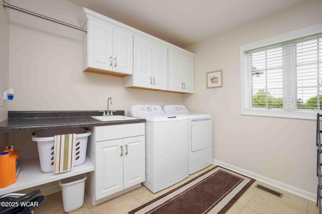 17210 State Route 694, Ottawa, OH 45875 - laundry room with cabinet space, washing machine and clothes dryer, baseboards, and light tile patterned floors