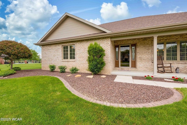 17210 State Route 694, Ottawa, OH 45875 - rear view of house featuring brick siding, a lawn, covered porch, and a shingled roof
