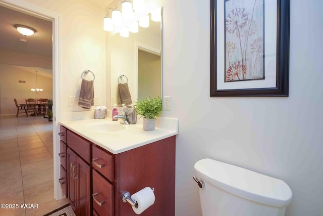 17210 State Route 694, Ottawa, OH 45875 - half bathroom with a chandelier, vanity, toilet, and tile patterned floors