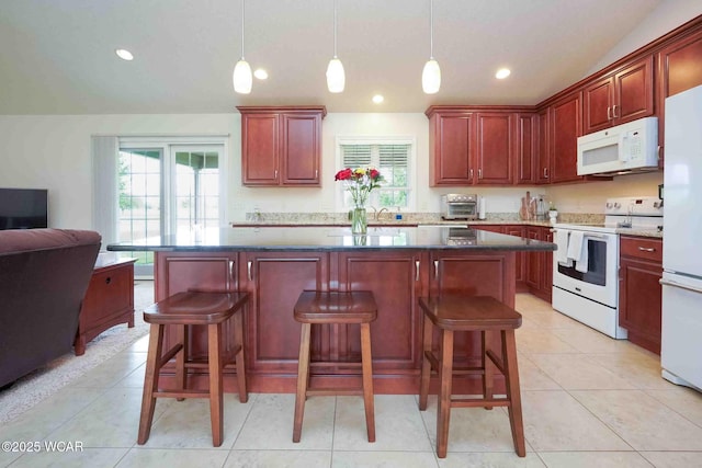 17210 State Route 694, Ottawa, OH 45875 - kitchen featuring white appliances, healthy amount of natural light, vaulted ceiling, open floor plan, and dark brown cabinets