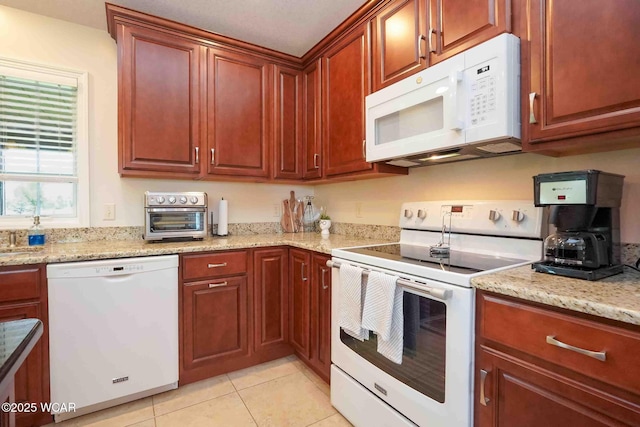 17210 State Route 694, Ottawa, OH 45875 - kitchen with white appliances, light tile patterned floors, and light stone counters