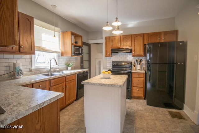 kitchen featuring visible vents, black appliances, under cabinet range hood, a sink, and light countertops