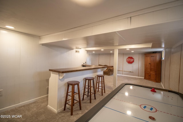 game room with bar area, carpet flooring, and baseboards