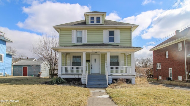 american foursquare style home with a front yard, covered porch, and a shingled roof