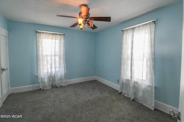 unfurnished room featuring baseboards, carpet, and a ceiling fan