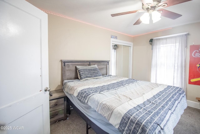 carpeted bedroom featuring a closet and ceiling fan