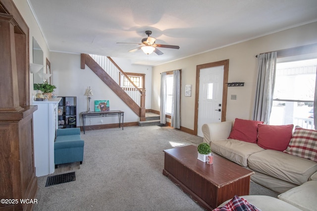 living room featuring stairs, carpet, visible vents, and a wealth of natural light