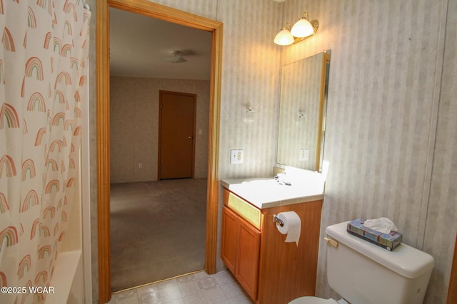 bathroom with tile patterned floors, toilet, wallpapered walls, and vanity