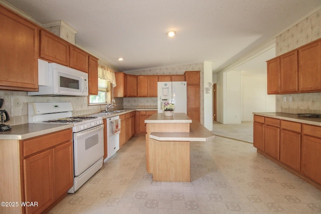 kitchen featuring white appliances, light floors, light countertops, tasteful backsplash, and a center island