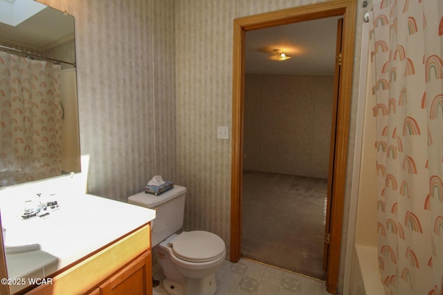 bathroom with toilet, wallpapered walls, vanity, and shower / bathtub combination with curtain