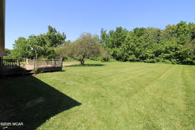 view of yard featuring a wooden deck