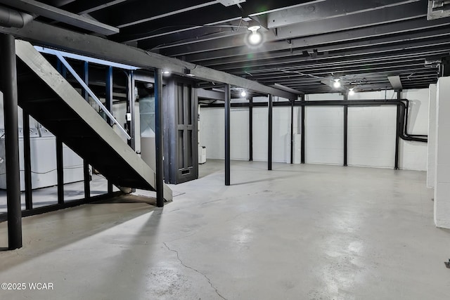 unfinished basement featuring washer / dryer