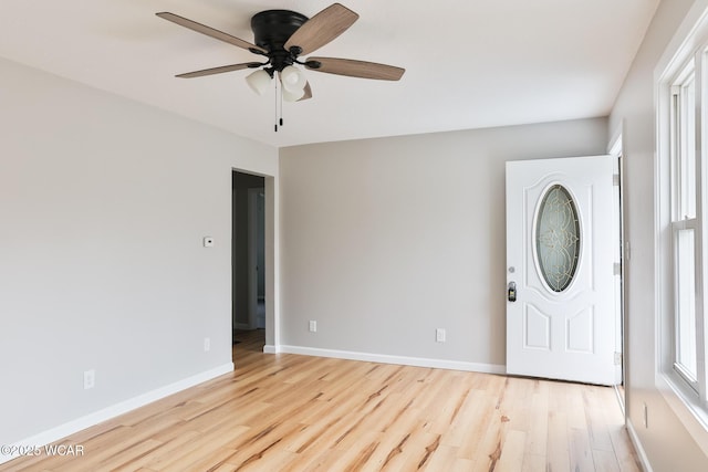 foyer featuring ceiling fan, light wood-style flooring, and baseboards