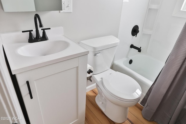 bathroom featuring shower / bath combo, vanity, toilet, and wood finished floors