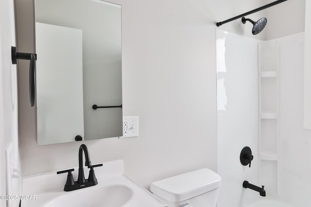 bathroom with shower / bath combination, a sink, and toilet