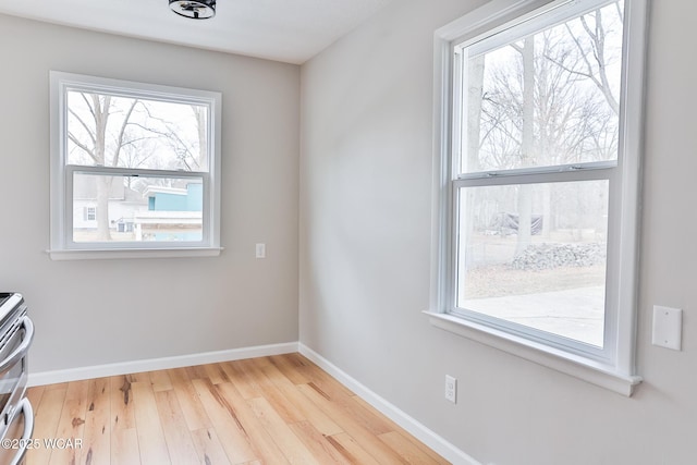 interior space featuring baseboards and wood finished floors