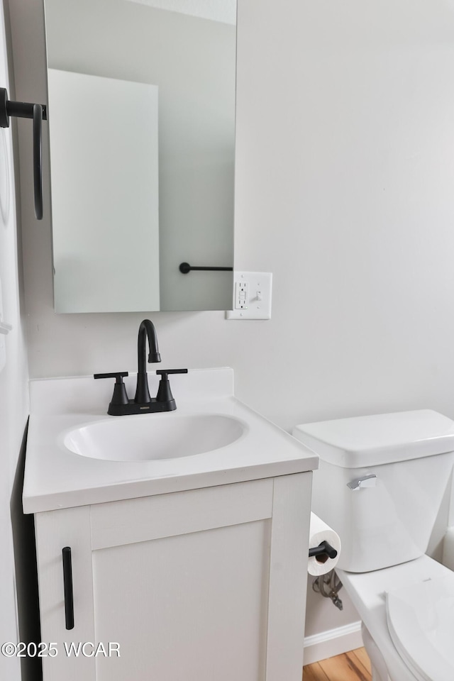 bathroom featuring toilet and vanity