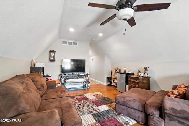 7407 Mingo Way, Russells Point, OH 43348 - living area with wood finished floors, lofted ceiling, ceiling fan, a textured ceiling, and recessed lighting
