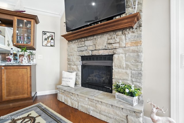 7407 Mingo Way, Russells Point, OH 43348 - living area featuring a fireplace, dark wood-style flooring, and ornamental molding