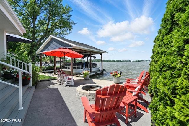 7407 Mingo Way, Russells Point, OH 43348 - view of patio with a fire pit, a water view, a dock, and boat lift