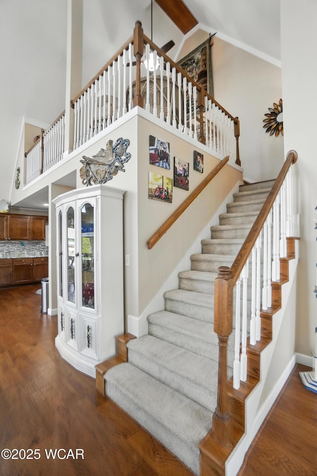 7407 Mingo Way, Russells Point, OH 43348 - staircase featuring wood finished floors and high vaulted ceiling