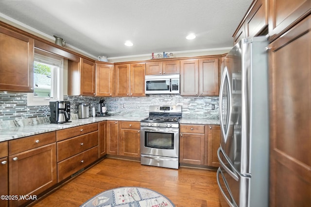 7407 Mingo Way, Russells Point, OH 43348 - kitchen with appliances with stainless steel finishes, brown cabinets, dark wood-style flooring, backsplash, and recessed lighting