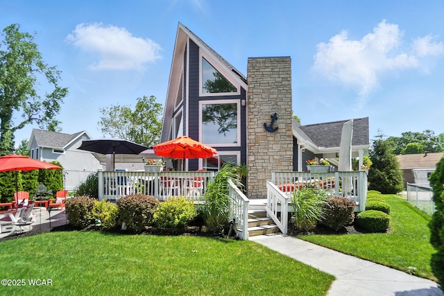 7407 Mingo Way, Russells Point, OH 43348 - view of front of house with a front yard, a chimney, and a deck