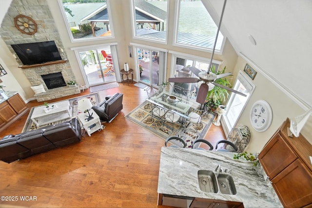 7407 Mingo Way, Russells Point, OH 43348 - living area with a high ceiling, a stone fireplace, and wood finished floors