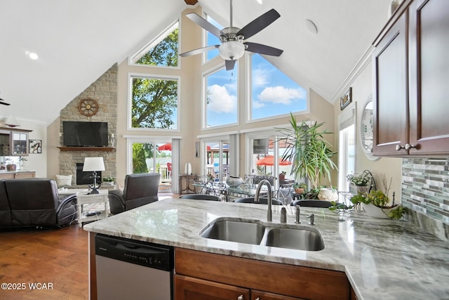 7407 Mingo Way, Russells Point, OH 43348 - kitchen featuring dishwasher, a fireplace, a ceiling fan, a peninsula, and high vaulted ceiling
