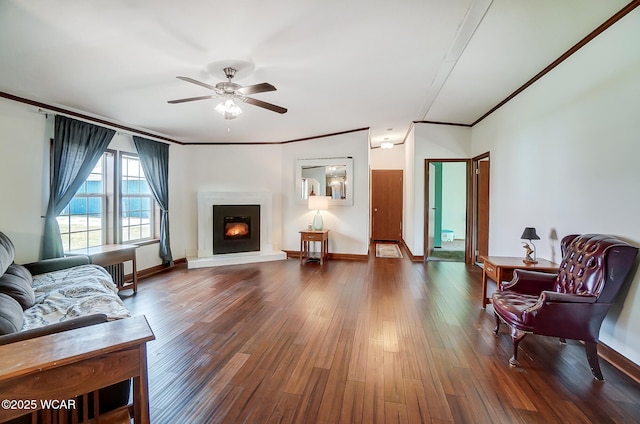 living room with crown molding, ceiling fan, and dark hardwood / wood-style floors