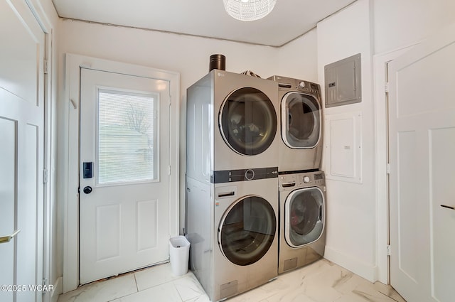 washroom with stacked washer and dryer and electric panel