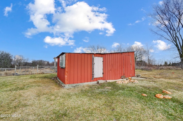 view of outbuilding featuring a lawn