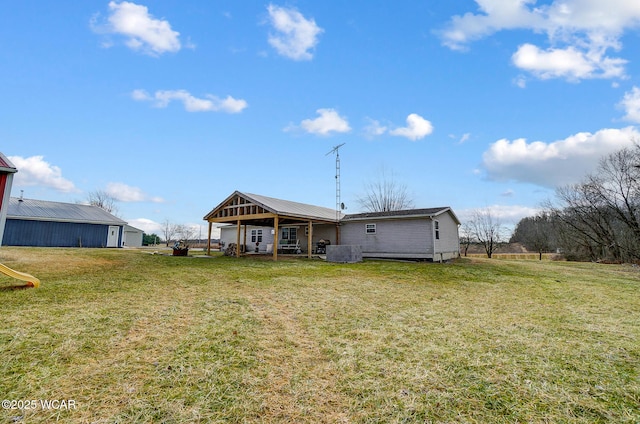 rear view of property featuring a yard