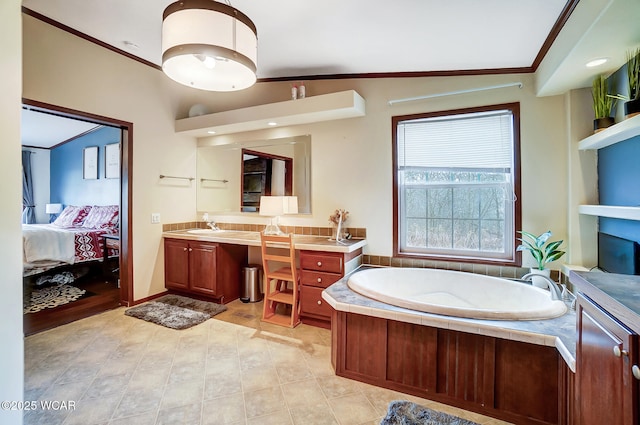 bathroom featuring crown molding, a tub, and vanity