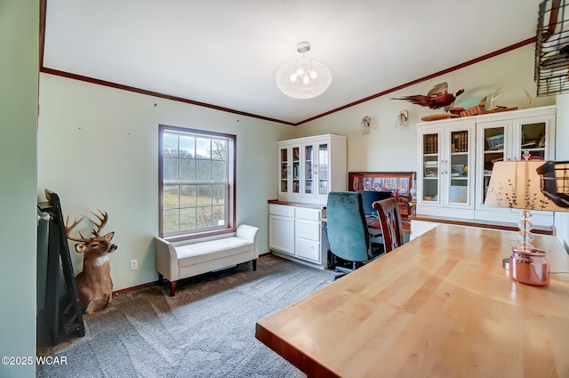 office area with a notable chandelier, dark carpet, and ornamental molding