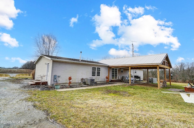 back of house with a yard and central AC unit