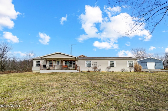 view of front of property featuring a garage, an outbuilding, covered porch, and a front lawn