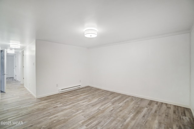 unfurnished room featuring light hardwood / wood-style flooring and a baseboard heating unit